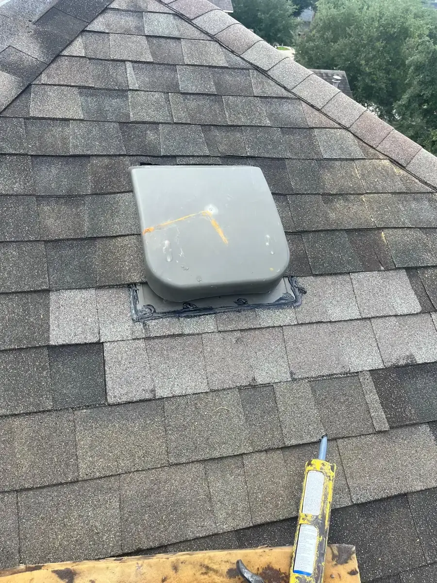 Gray box vent installed among restored asphalt shingles