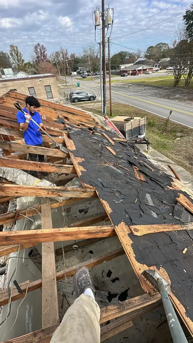 Roof covering and decking removed to expose timber framing during a reroof