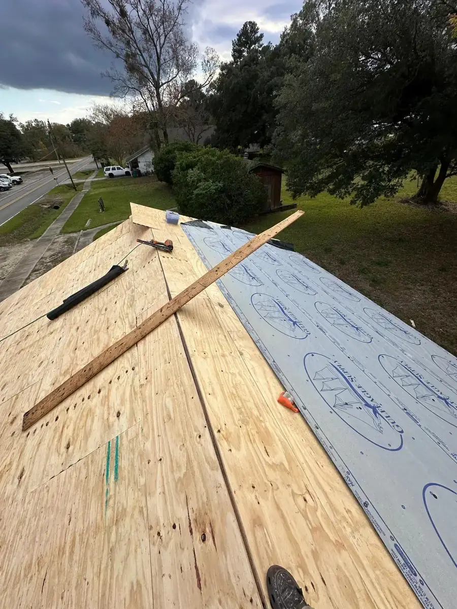 Plywood roof decking beside newly laid synthetic underlayment