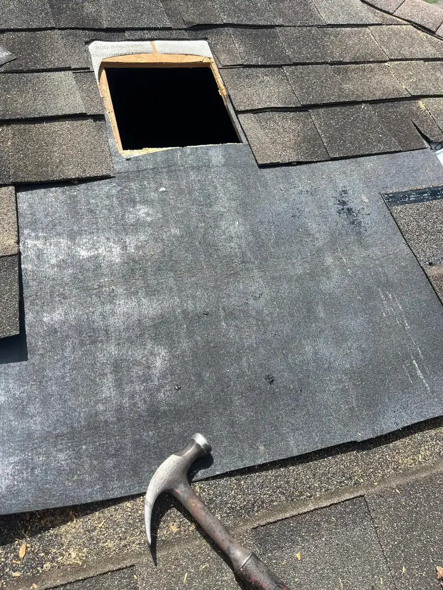 Black underlayment laid over repaired decking below a roof vent opening